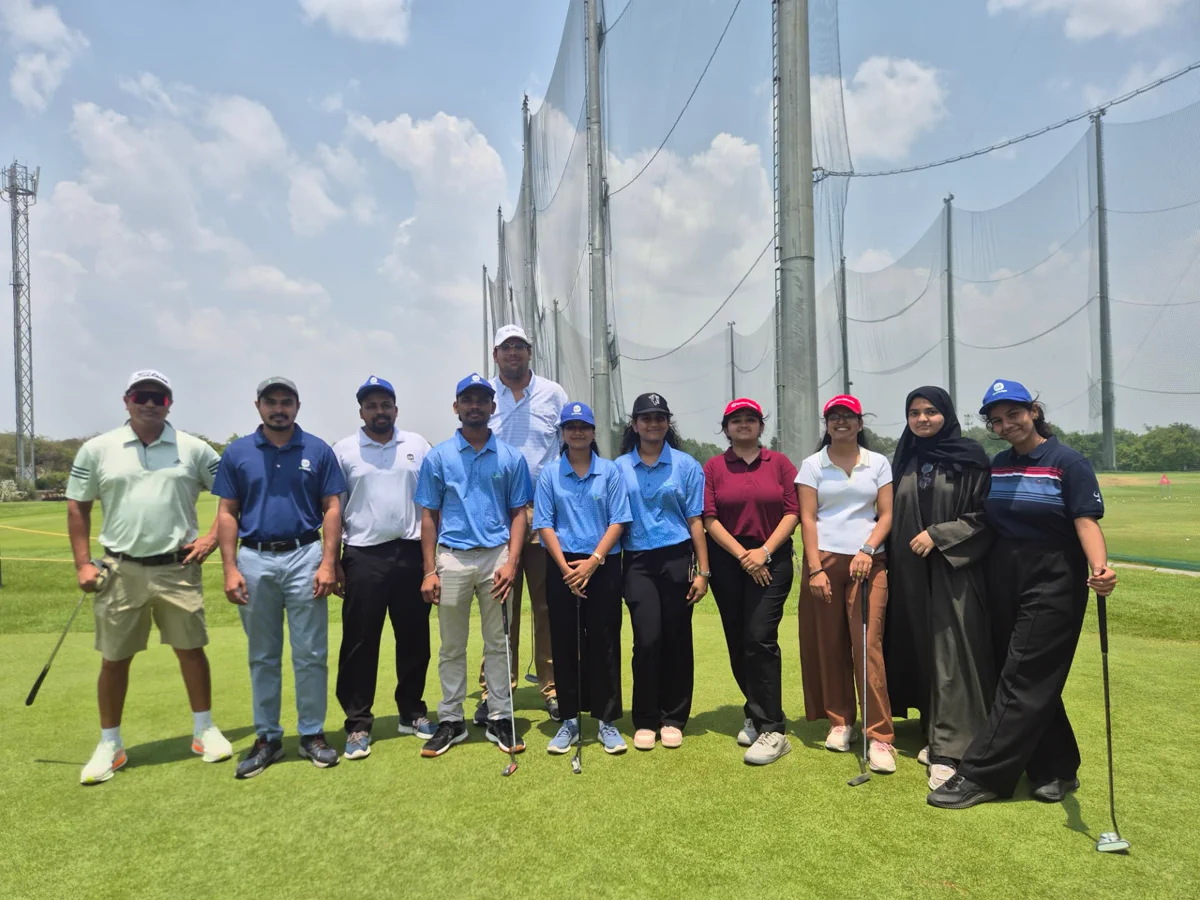 Group coaching session under the nets at the driving range